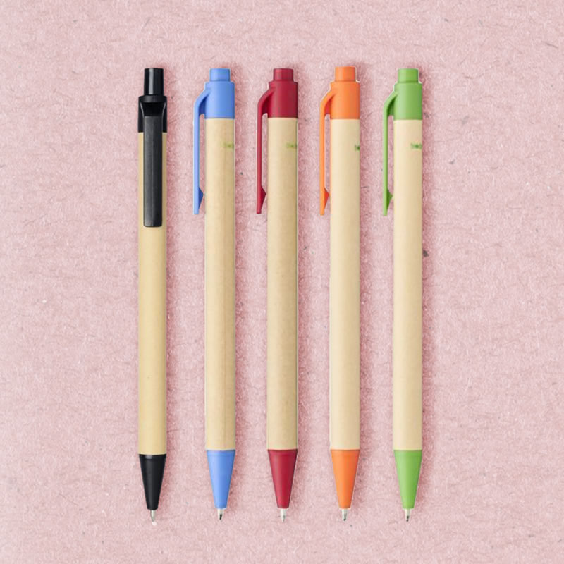 plant-based, biodegradable pens layed out on the background, which is a pale pink paper stock